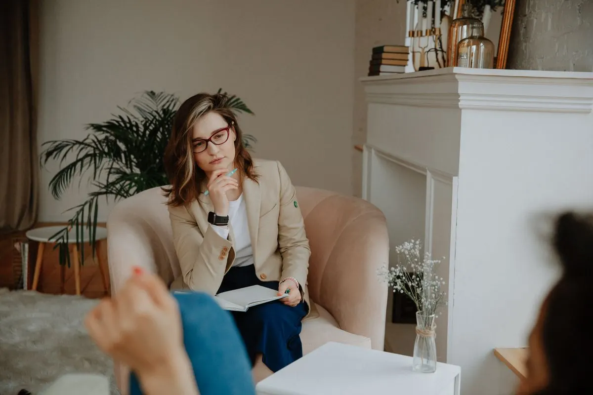 Two people having a thoughtful conversation in a calm room